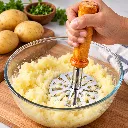 Hand Masher in Creamy Potatoes.webp